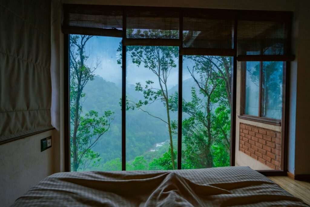 a bedroom with a view of the mountains outside the window